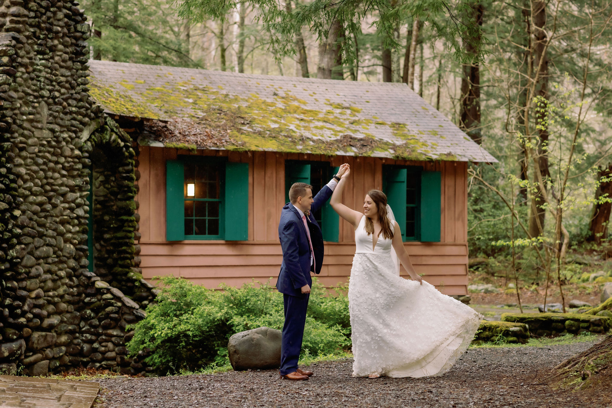 bride and groom dancing at Smoky Mountain wedding venue in front of a cabin in the woods